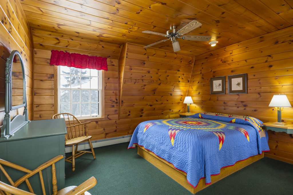 Room on our west wing knotty pine wing. Handmade colorful Amish quilt.